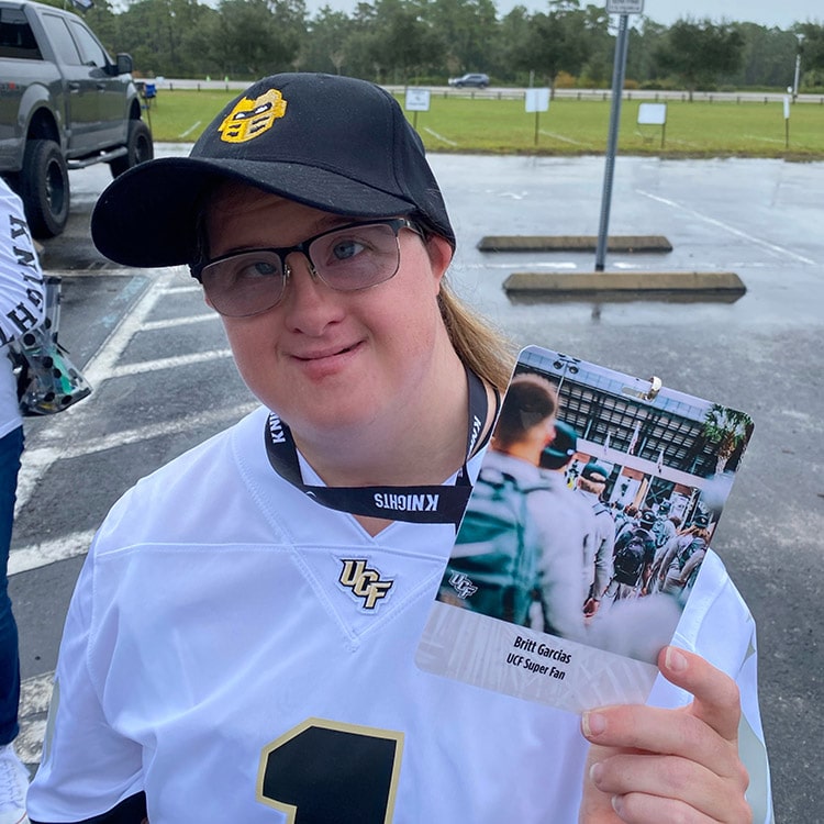 Britt posing with her UCF Super Fan card on a lanyard around her neck