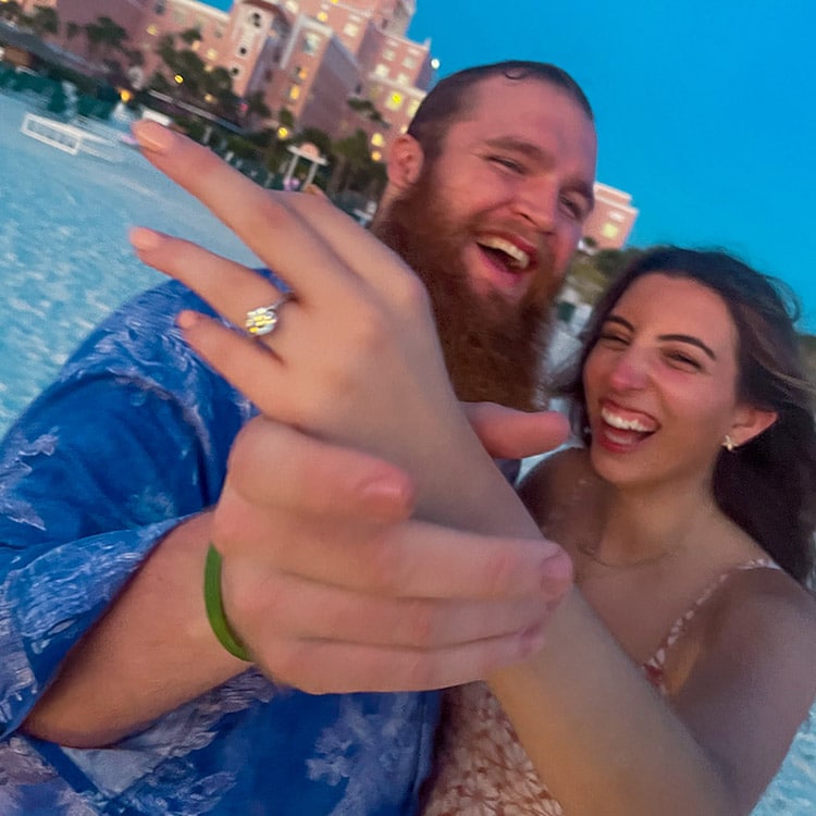 Dillan Gibbons posing with his fiancé after proposing on the beach