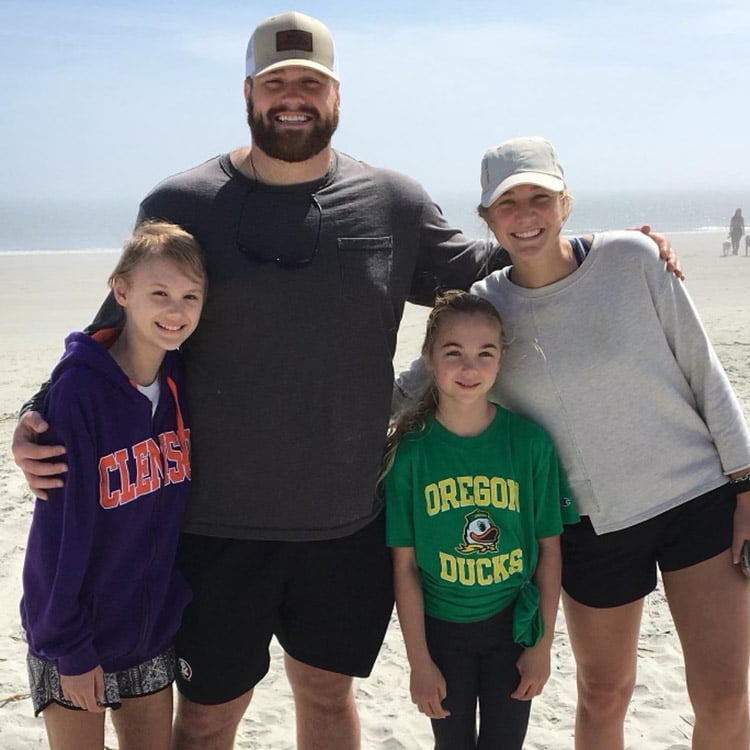 Brady Scott posing with the Liana Joy family on the beach
